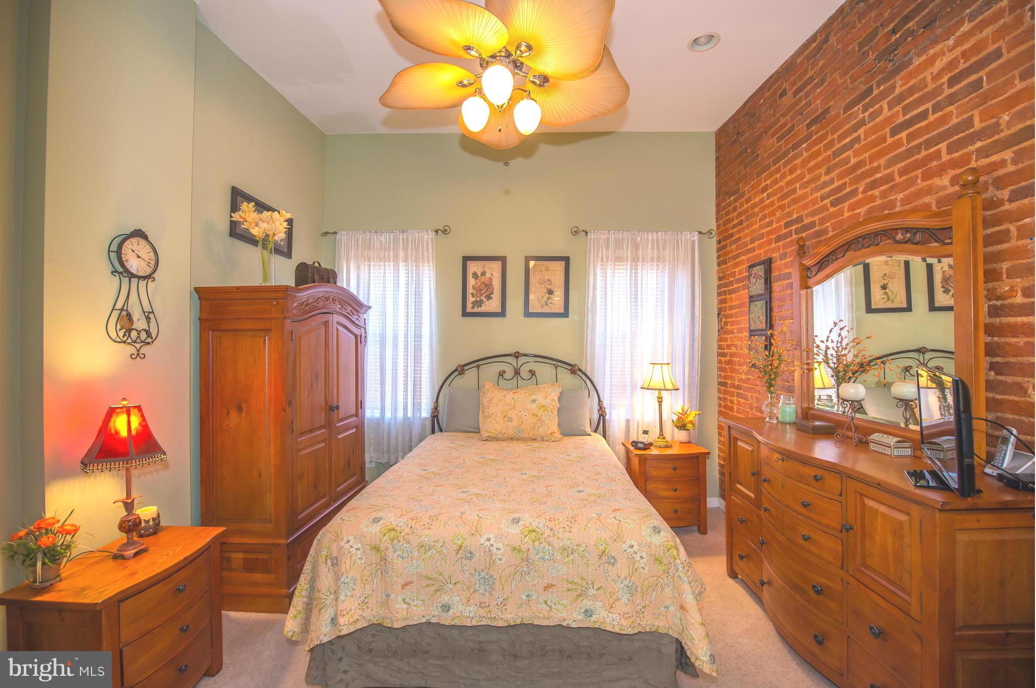 819 South Potomac Street Baltimore, MD 21224 - Photo 15 of 30 a bedroom with a bed and a chandelier