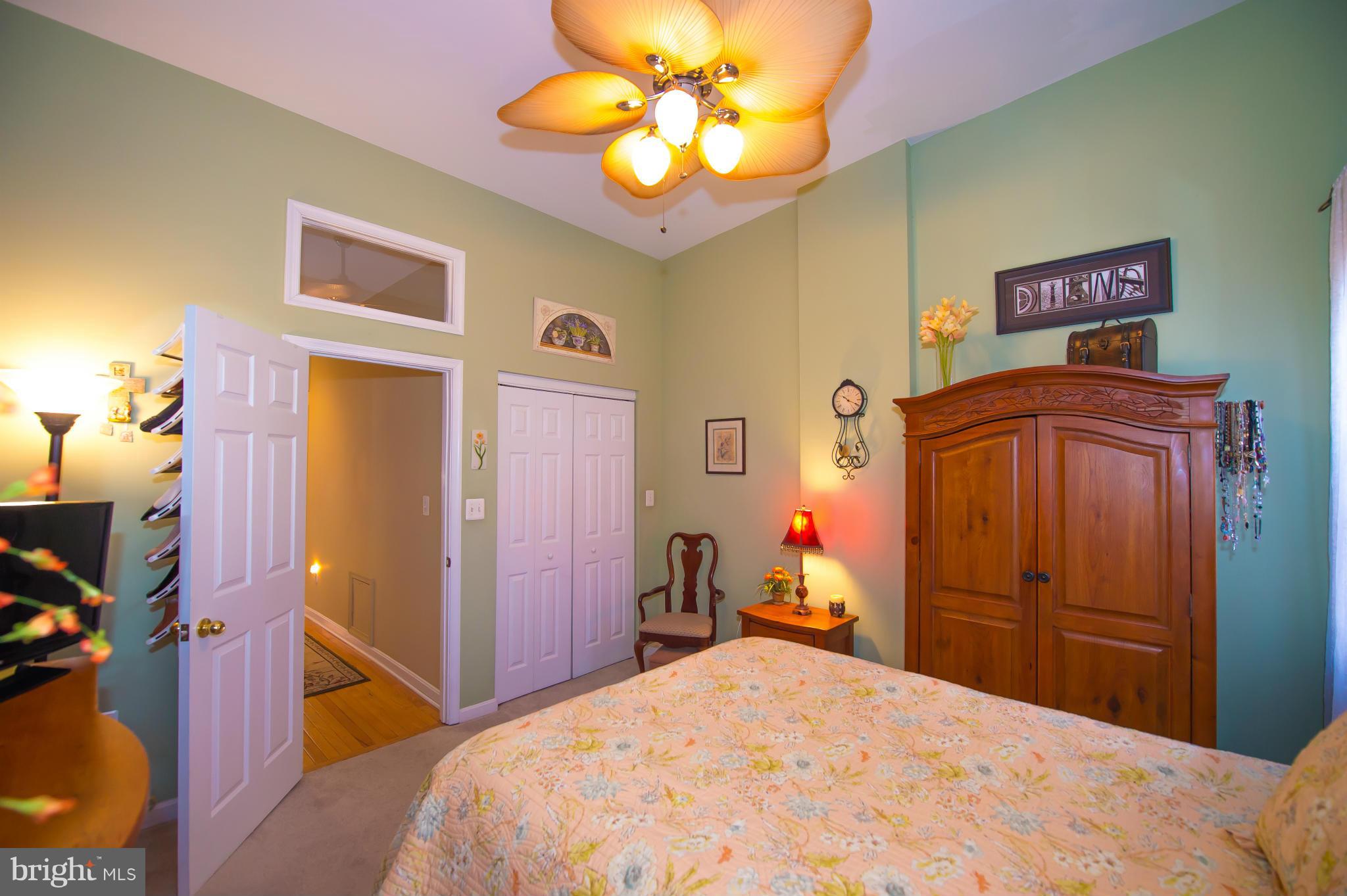 819 South Potomac Street Baltimore, MD 21224 - Photo 17 of 30 a bedroom with a bed and a chandelier
