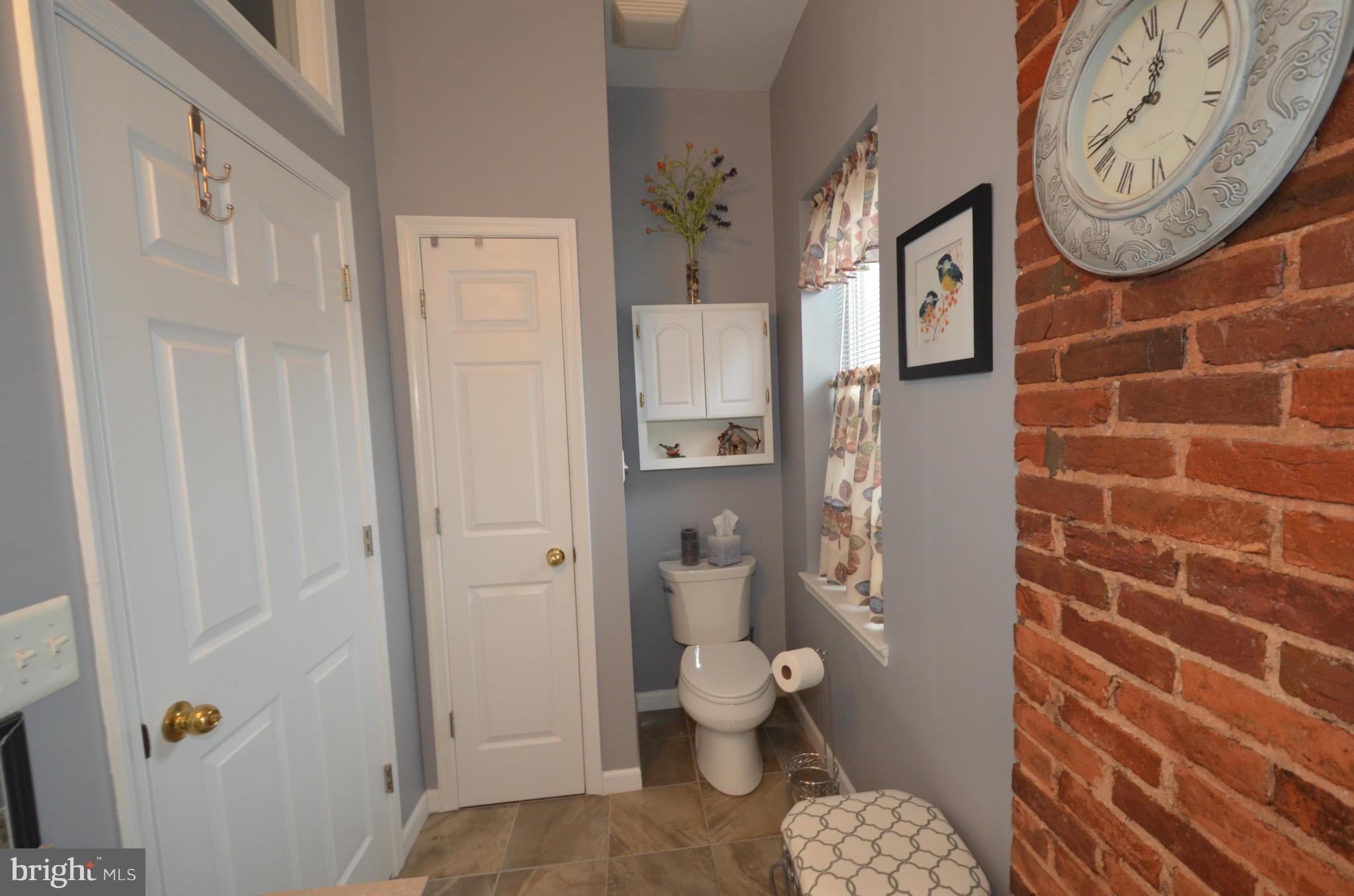 819 South Potomac Street Baltimore, MD 21224 - Photo 19 of 30 a bathroom with a toilet and a shower