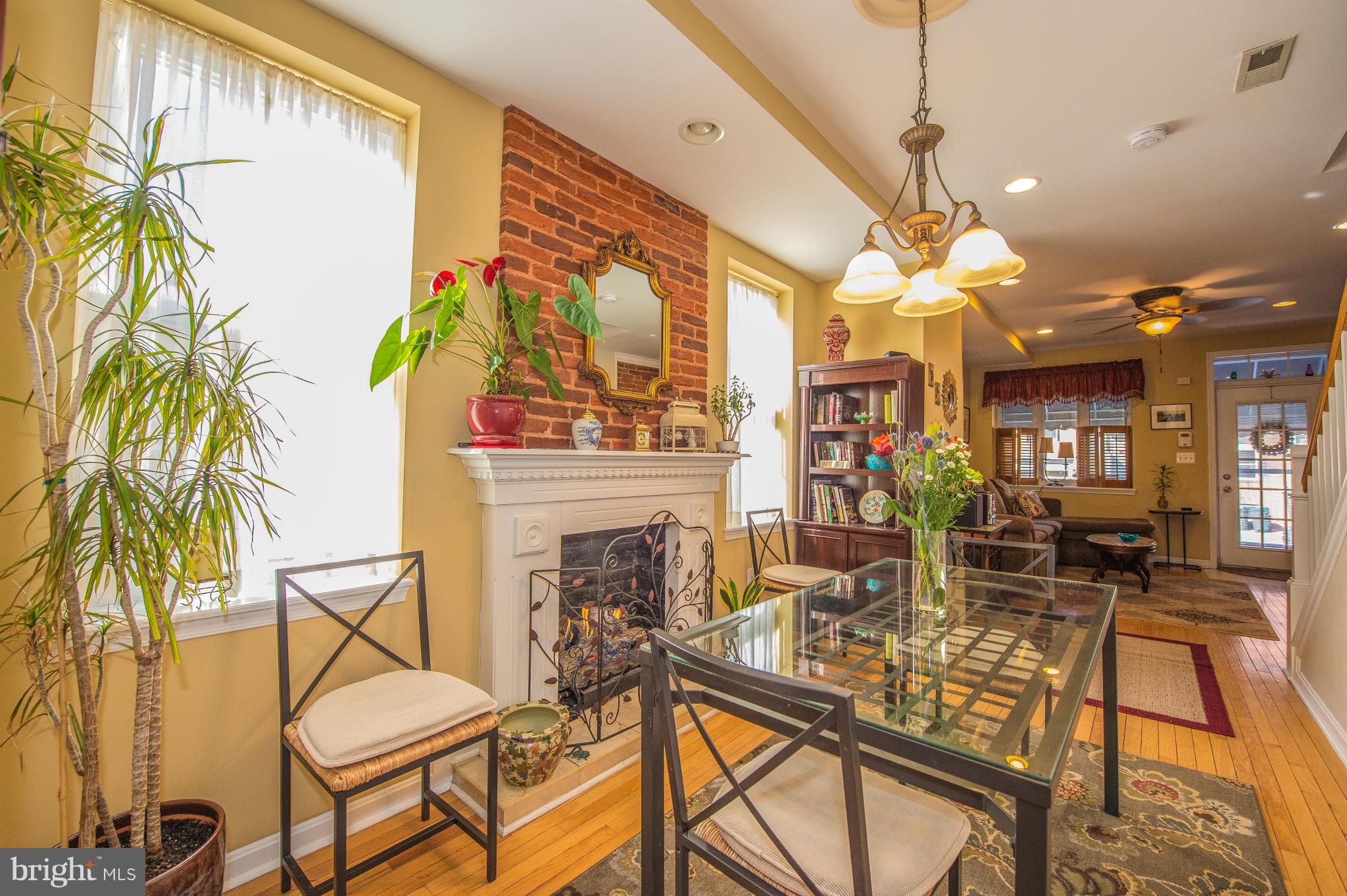 819 South Potomac Street Baltimore, MD 21224 - Photo 7 of 30 a view of a dining room with furniture a chandelier and wooden floor