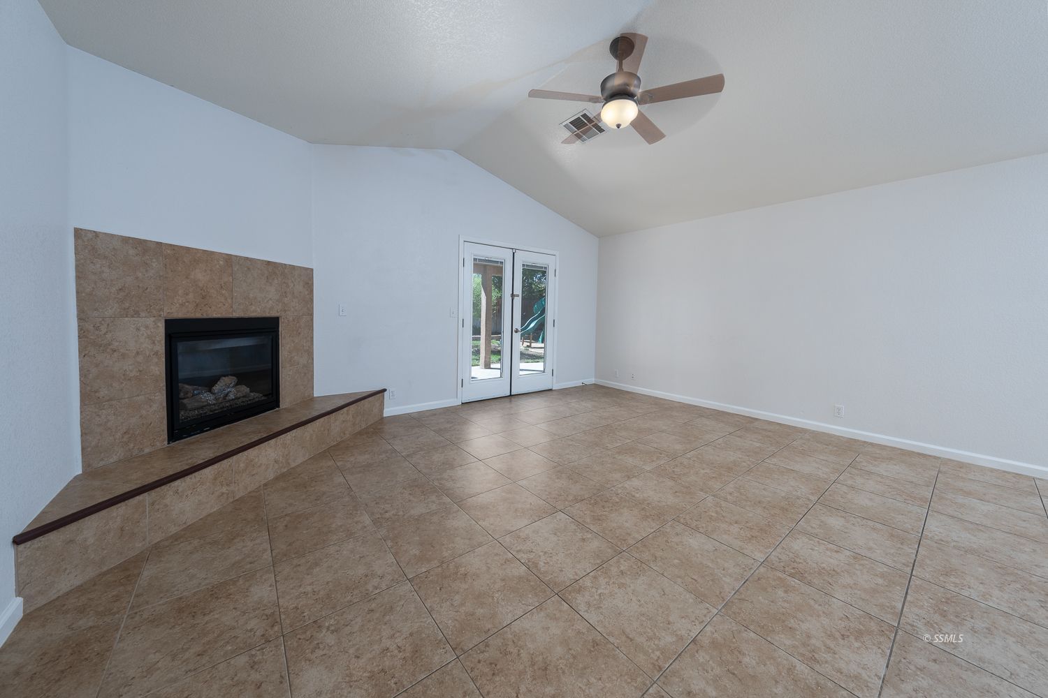 1009 Sims Street Ridgecrest, CA 93555 - Photo 4 of 40 a view of an empty room with chandelier fan and fire place
