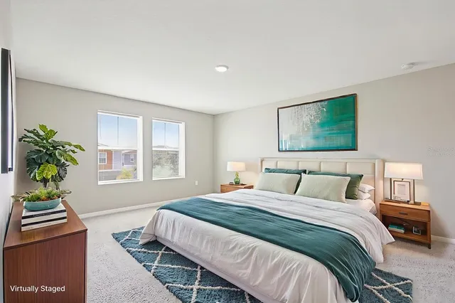 a bedroom with a bed table and a window