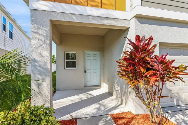 a vase of flowers sitting on a brick wall