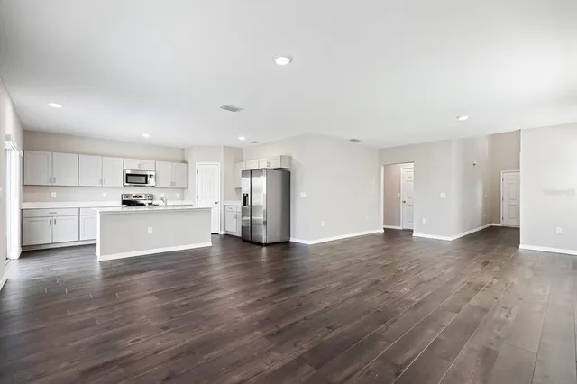 a view of a kitchen with a sink and a refrigerator