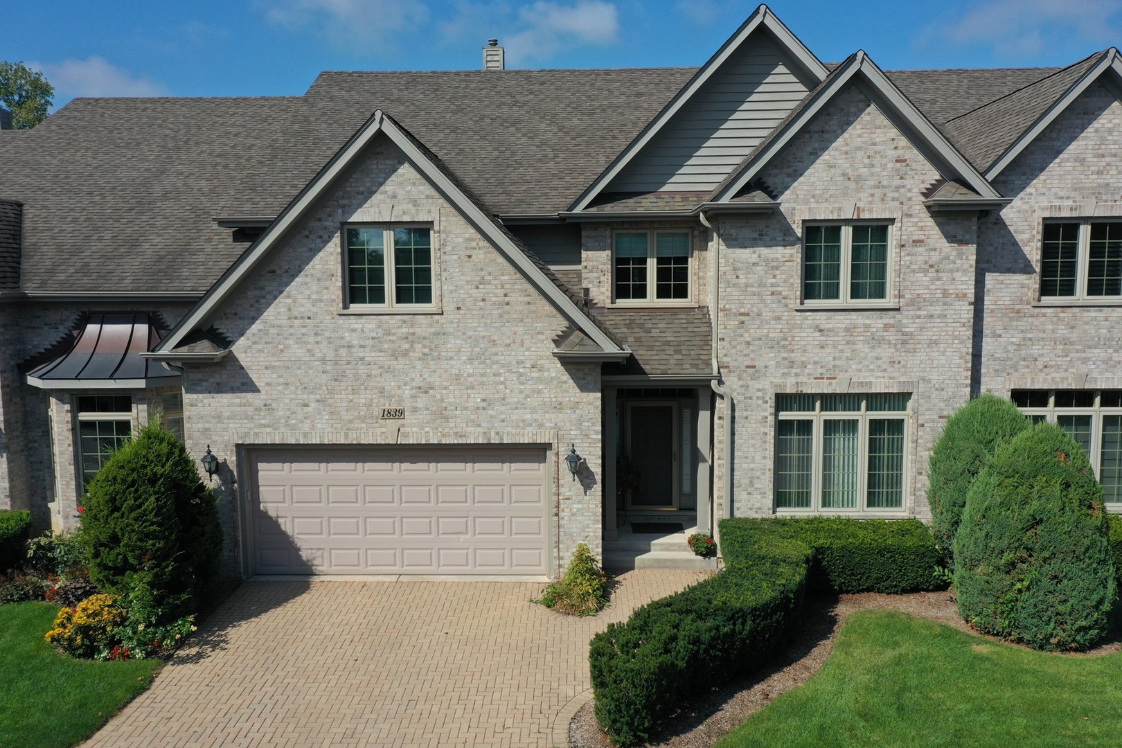 1839 Rizzi Lane Bartlett, IL 60103 - Photo 1 of 50 a front view of a house with a garden and plants