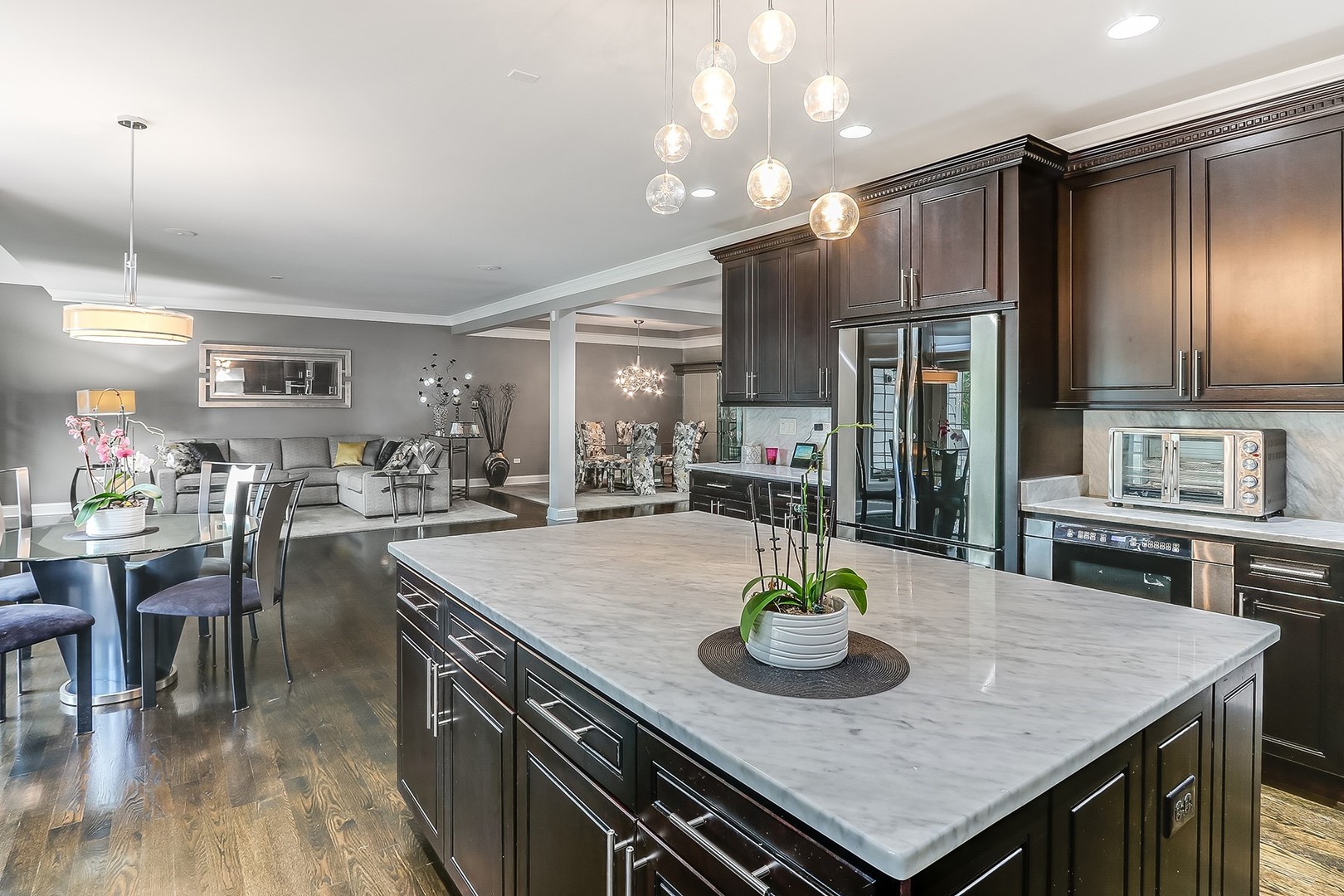 1839 Rizzi Lane Bartlett, IL 60103 - Photo 19 of 50 a kitchen with granite countertop a table chairs stove and refrigerator
