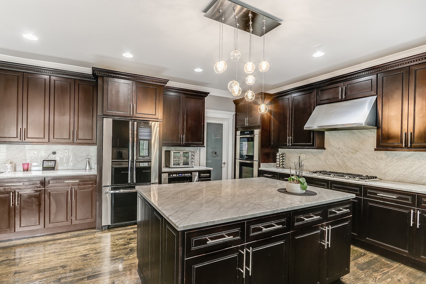 1839 Rizzi Lane Bartlett, IL 60103 - Photo 20 of 50 a kitchen with stainless steel appliances granite countertop a sink a stove and cabinets