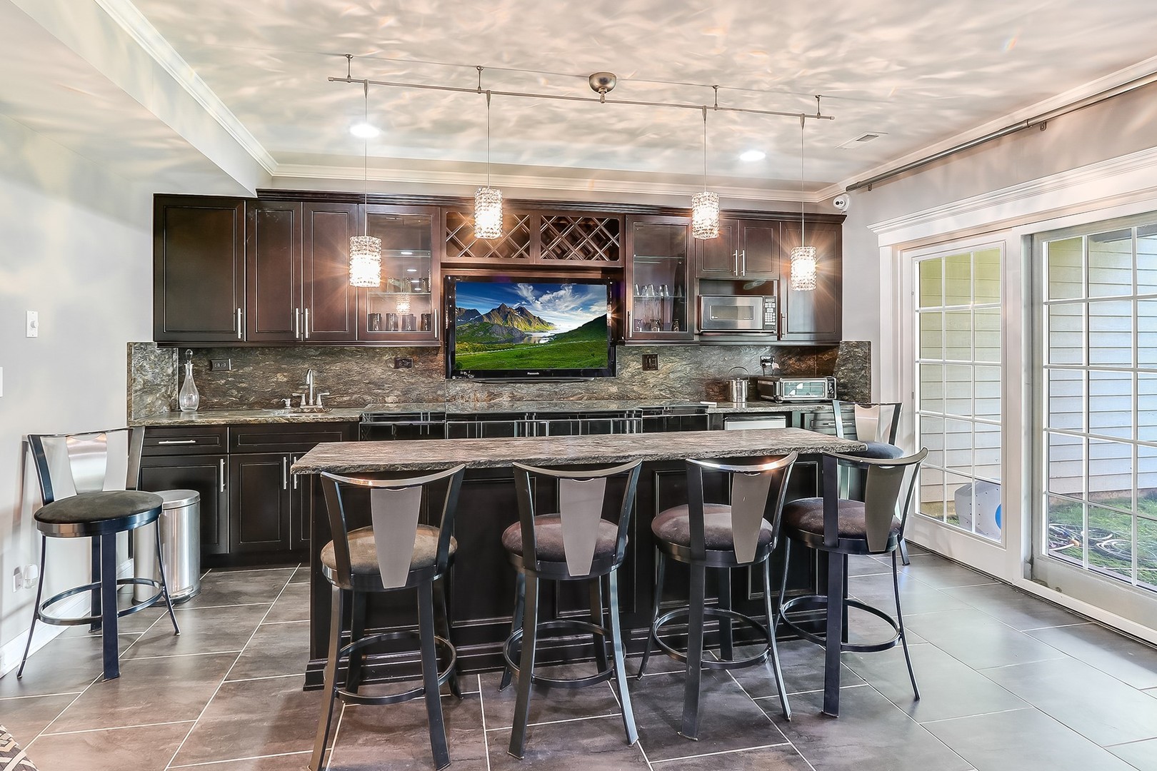 1839 Rizzi Lane Bartlett, IL 60103 - Photo 36 of 50 a kitchen with stainless steel appliances kitchen island granite countertop a table chairs sink and cabinets