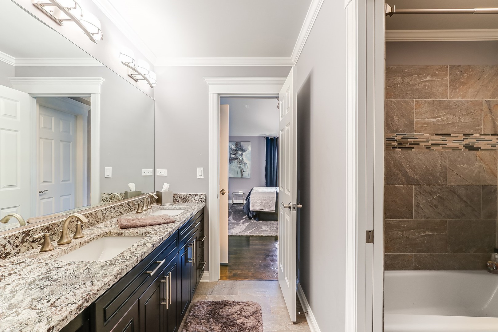 1839 Rizzi Lane Bartlett, IL 60103 - Photo 39 of 50 a bathroom with a granite countertop sink a mirror and a bathtub