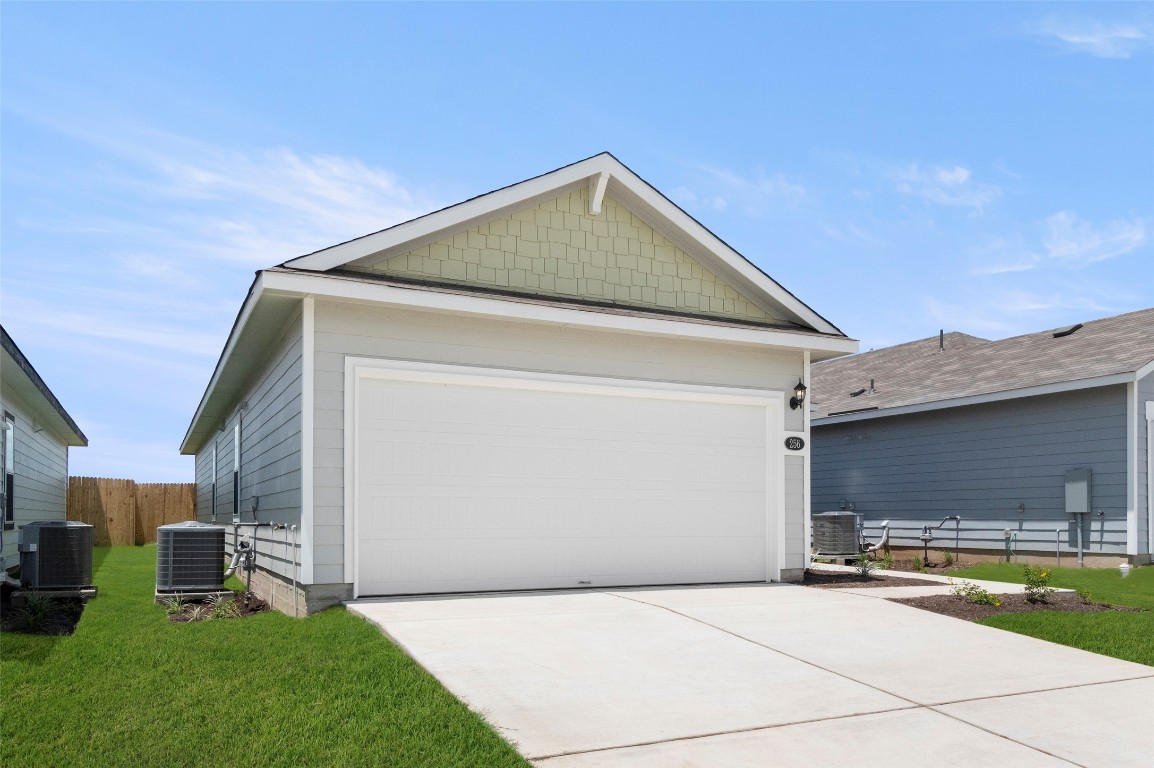 a view of backyard of house and car parked