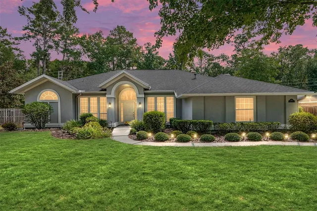 a front view of a house with garden and porch