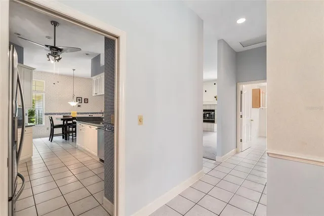 an empty room with windows and fireplace