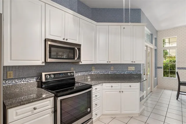 a view of a dining room with furniture and a kitchen