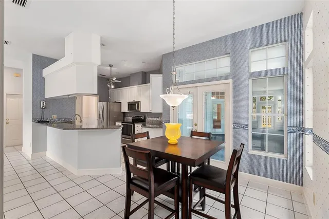 an empty room with chandelier fan