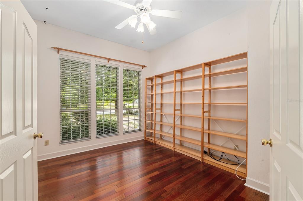 7015 Northwest 47th Terrace Gainesville, FL 32653 - Photo 33 of 49 a view of an empty room with a window and wooden floor