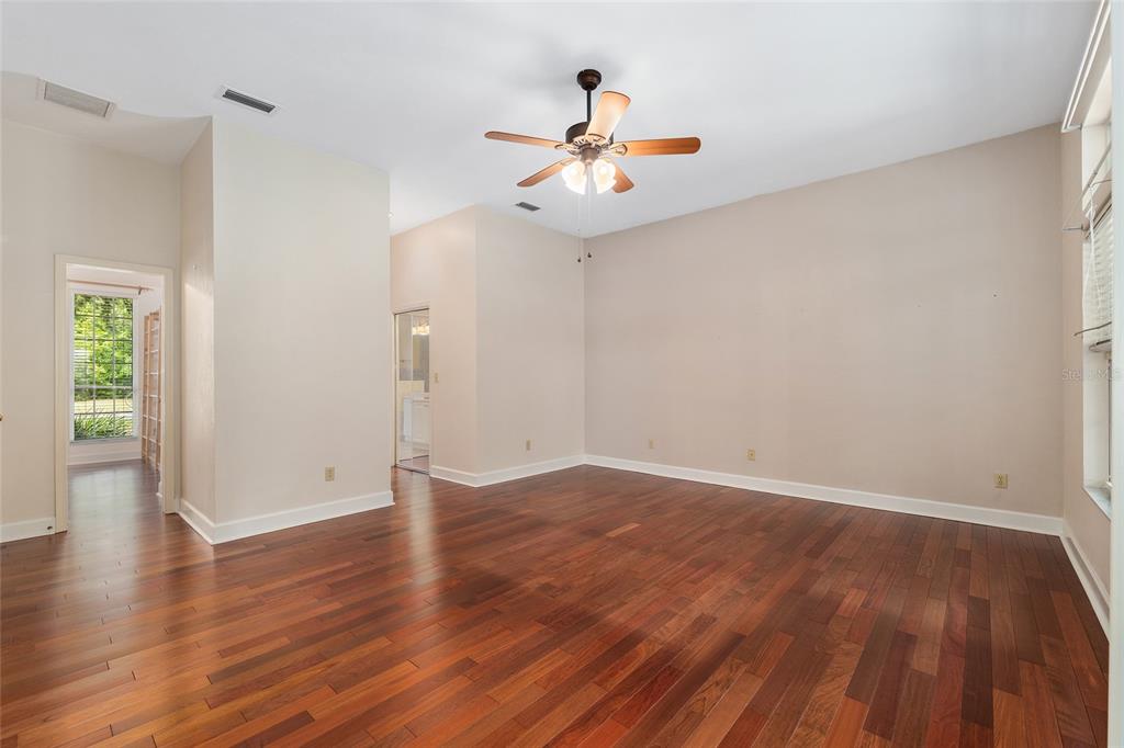 7015 Northwest 47th Terrace Gainesville, FL 32653 - Photo 35 of 49 an empty room with wooden floor and windows
