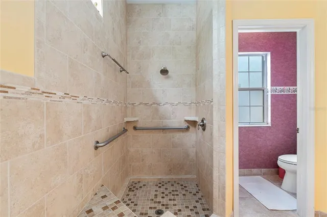 a bathroom with a sink toilet and mirror