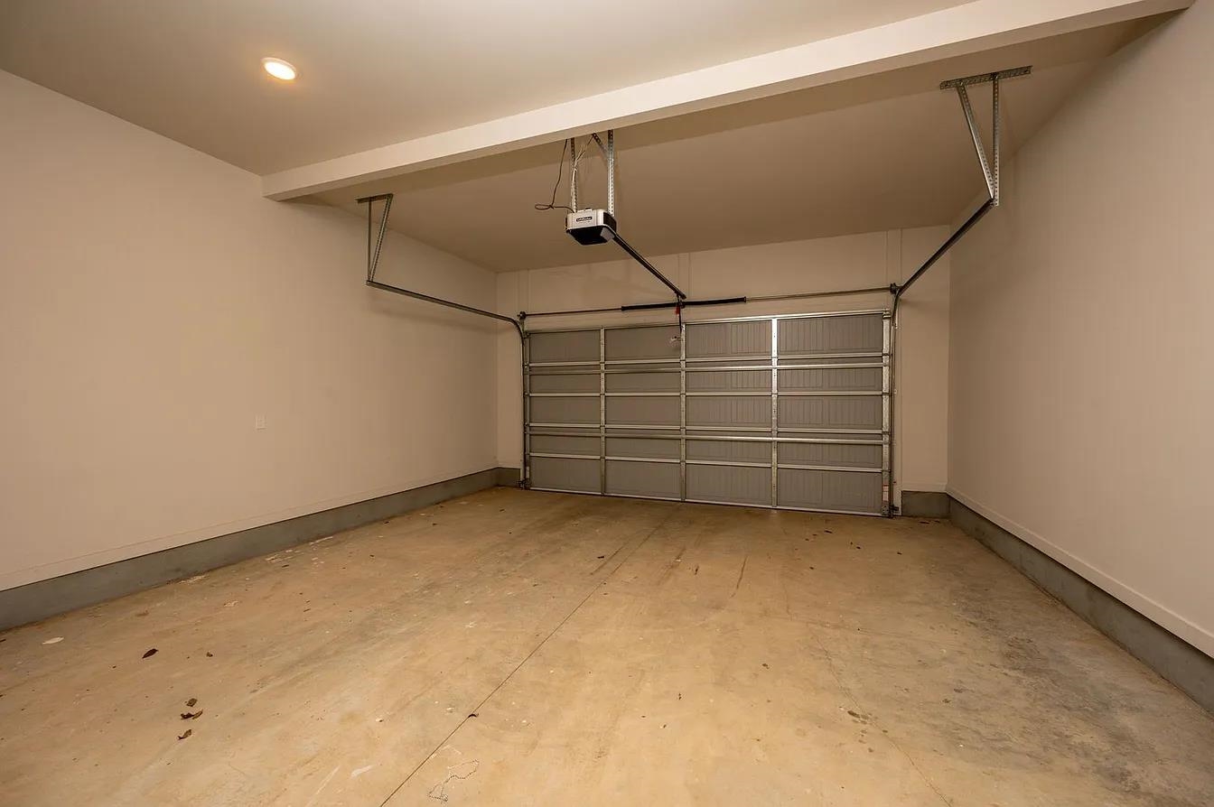 752 Meda Street Memphis, TN 38104 - Photo 18 of 18 Single-bay garage featuring an automatic overhead door opener and light-toned walls