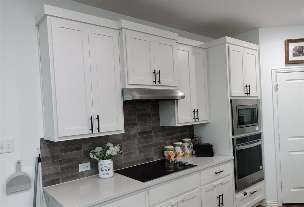 505 Virginia Way Princeton, TX 75407 - Photo 13 of 22 a kitchen with stainless steel appliances a white cabinets and a stove top oven