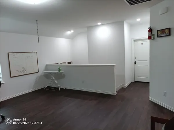 a workspace with furniture and a wooden floor