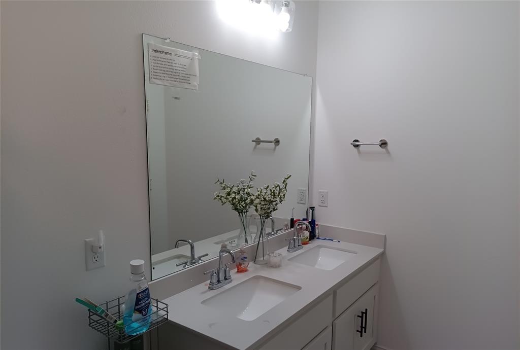 505 Virginia Way Princeton, TX 75407 - Photo 18 of 22 a bathroom with a sink vanity and a mirror