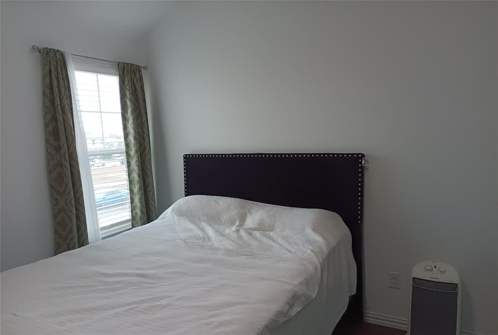 505 Virginia Way Princeton, TX 75407 - Photo 20 of 22 a bedroom with a bed and a window