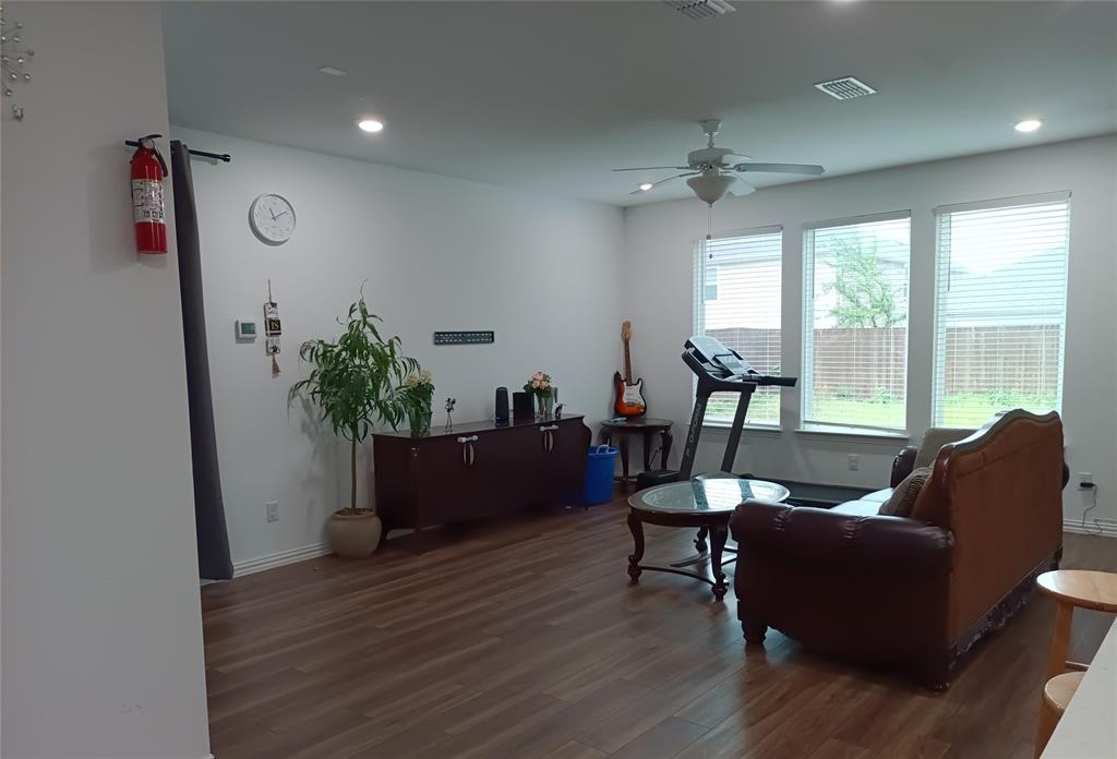 505 Virginia Way Princeton, TX 75407 - Photo 2 of 22 a living room with furniture and a potted plant