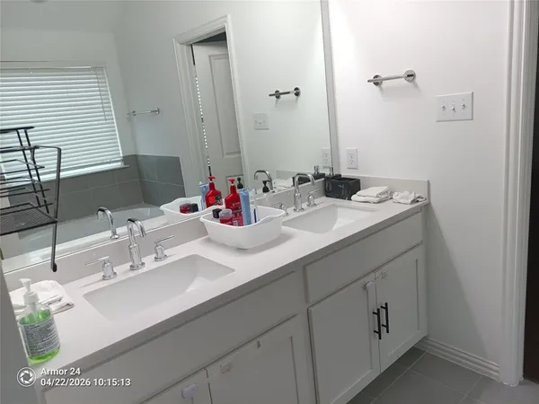 a bathroom with a shower sink and mirror