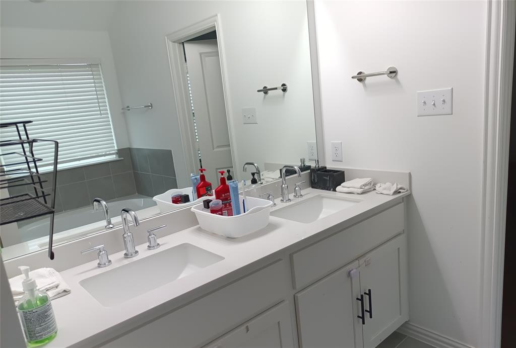 505 Virginia Way Princeton, TX 75407 - Photo 7 of 22 a bathroom with a sink and a mirror