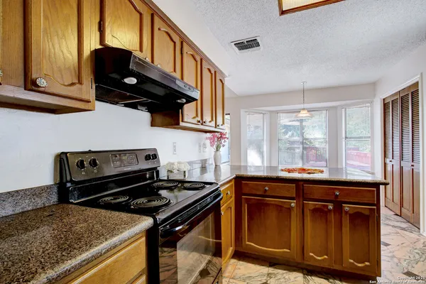 a kitchen with stainless steel appliances granite countertop a stove and a sink