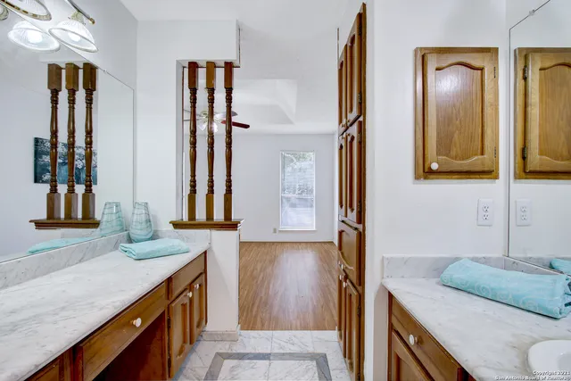 a bathroom with double vanity sink and a mirror