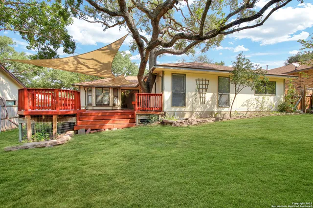a front view of a house with a yard table and chairs