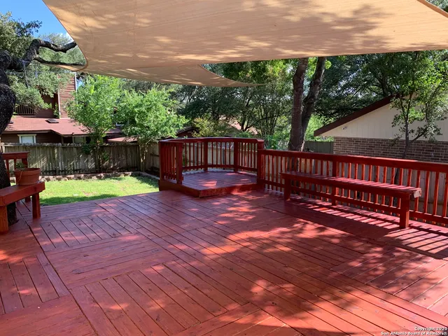 a view of a backyard with a tub and wooden fence