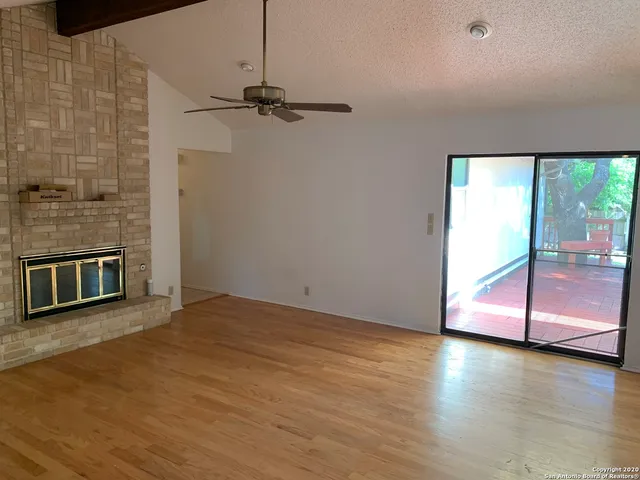 a view of a room with wooden floor and window