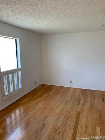 a view of an empty room and wooden floor