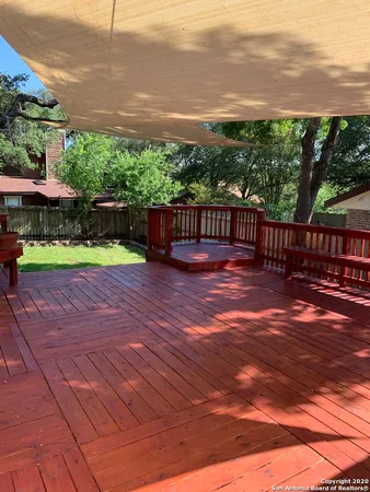 a view of a yard with a wooden fence