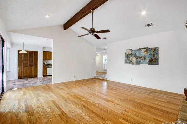 wooden floor in an empty room with a window