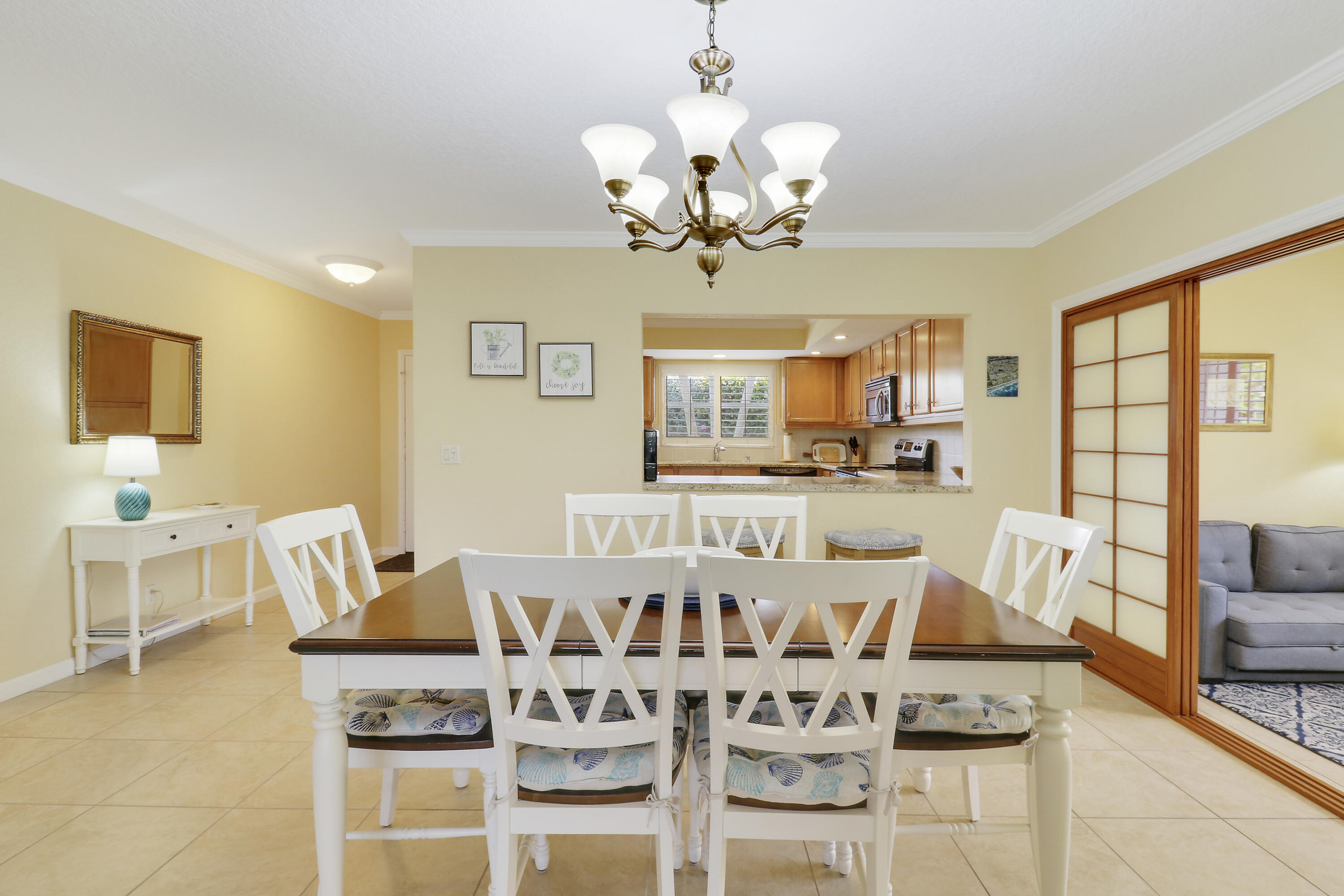 4161 U.S. Highway 1, Unit C2 Jupiter, FL 33477 - Photo 18 of 57 a view of a dining room with furniture and a chandelier