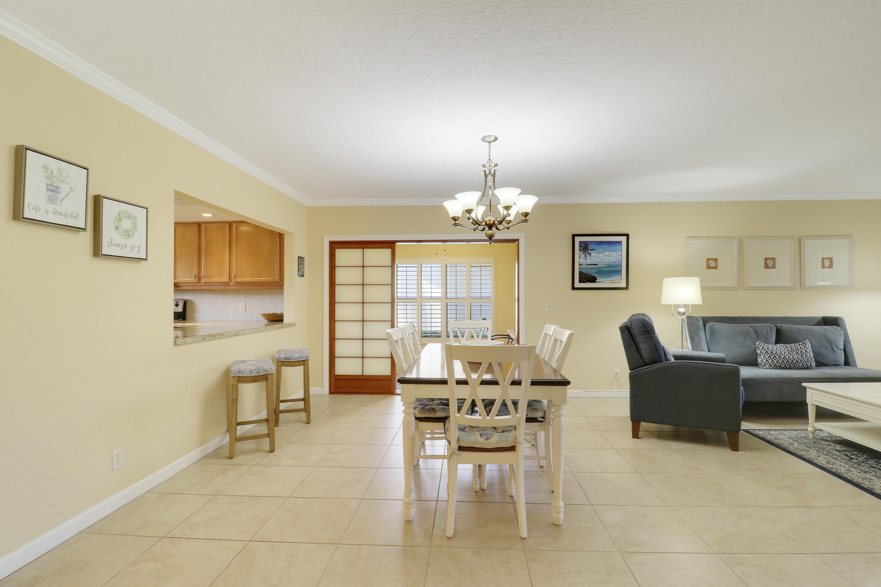 4161 U.S. Highway 1, Unit C2 Jupiter, FL 33477 - Photo 23 of 57 a view of a livingroom with furniture and chandelier