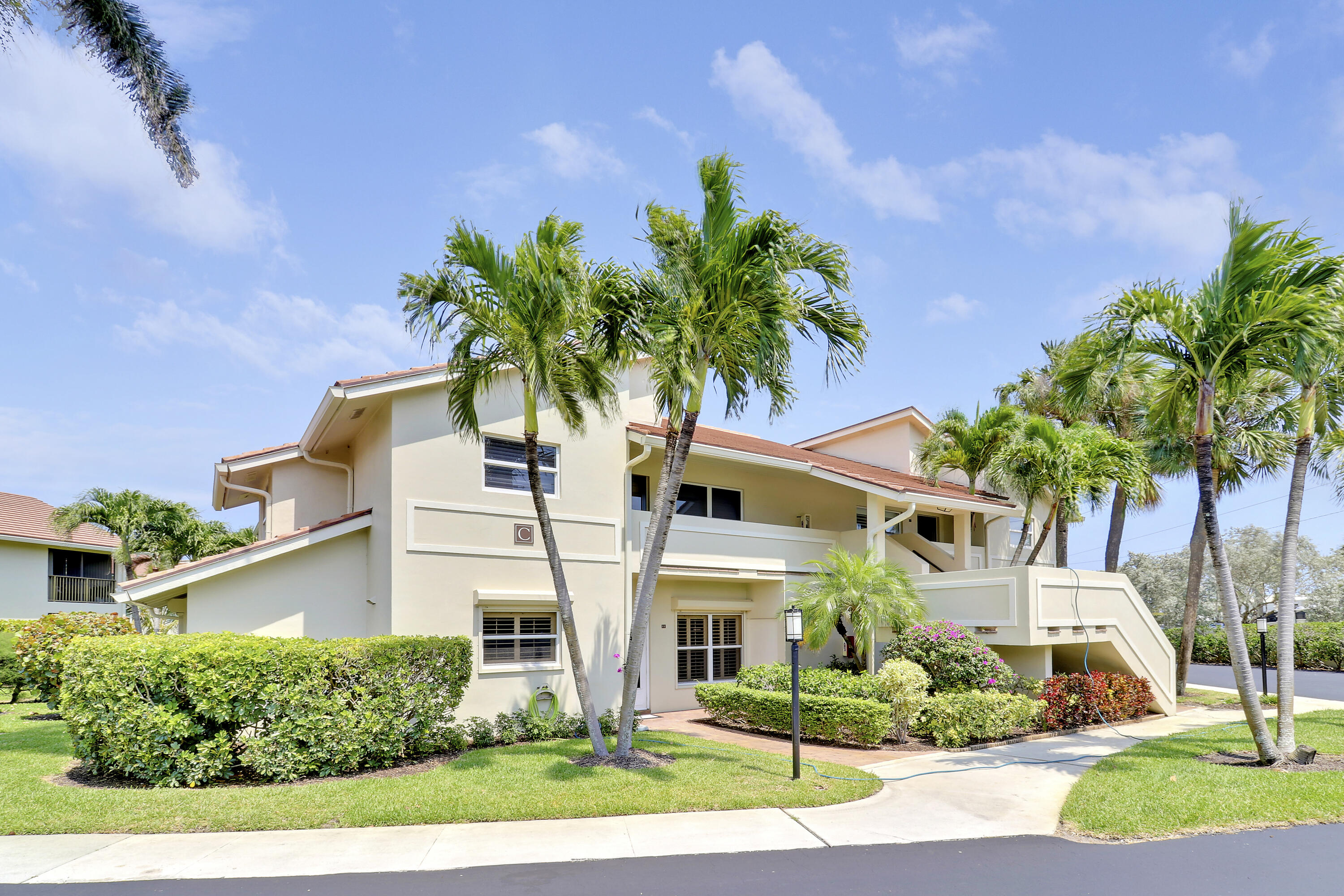 4161 U.S. Highway 1, Unit C2 Jupiter, FL 33477 - Photo 3 of 57 a front view of a house with a yard and garage