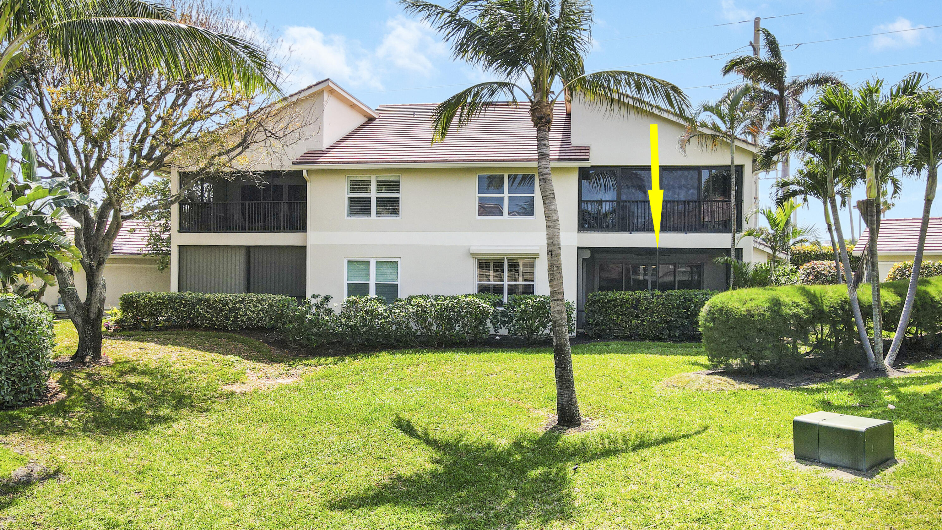 4161 U.S. Highway 1, Unit C2 Jupiter, FL 33477 - Photo 36 of 57 a view of a white house with a yard and plants