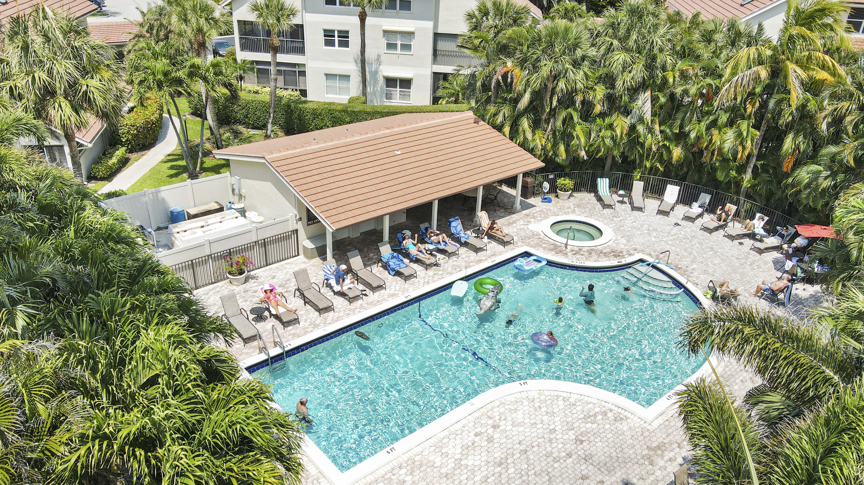 4161 U.S. Highway 1, Unit C2 Jupiter, FL 33477 - Photo 39 of 57 a view of a backyard with table and chairs with potted plants