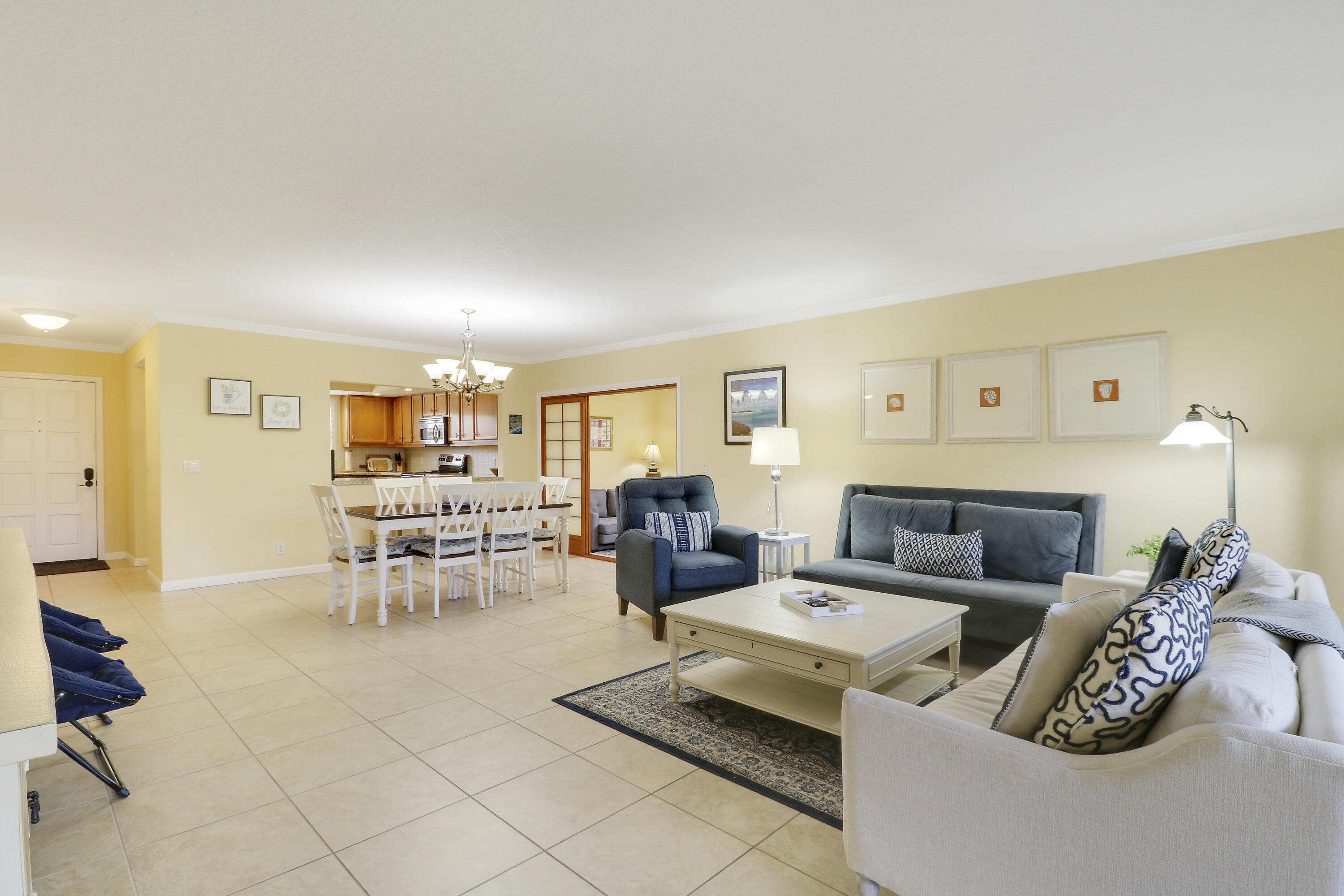 4161 U.S. Highway 1, Unit C2 Jupiter, FL 33477 - Photo 5 of 57 a living room with furniture and a dining table with chairs