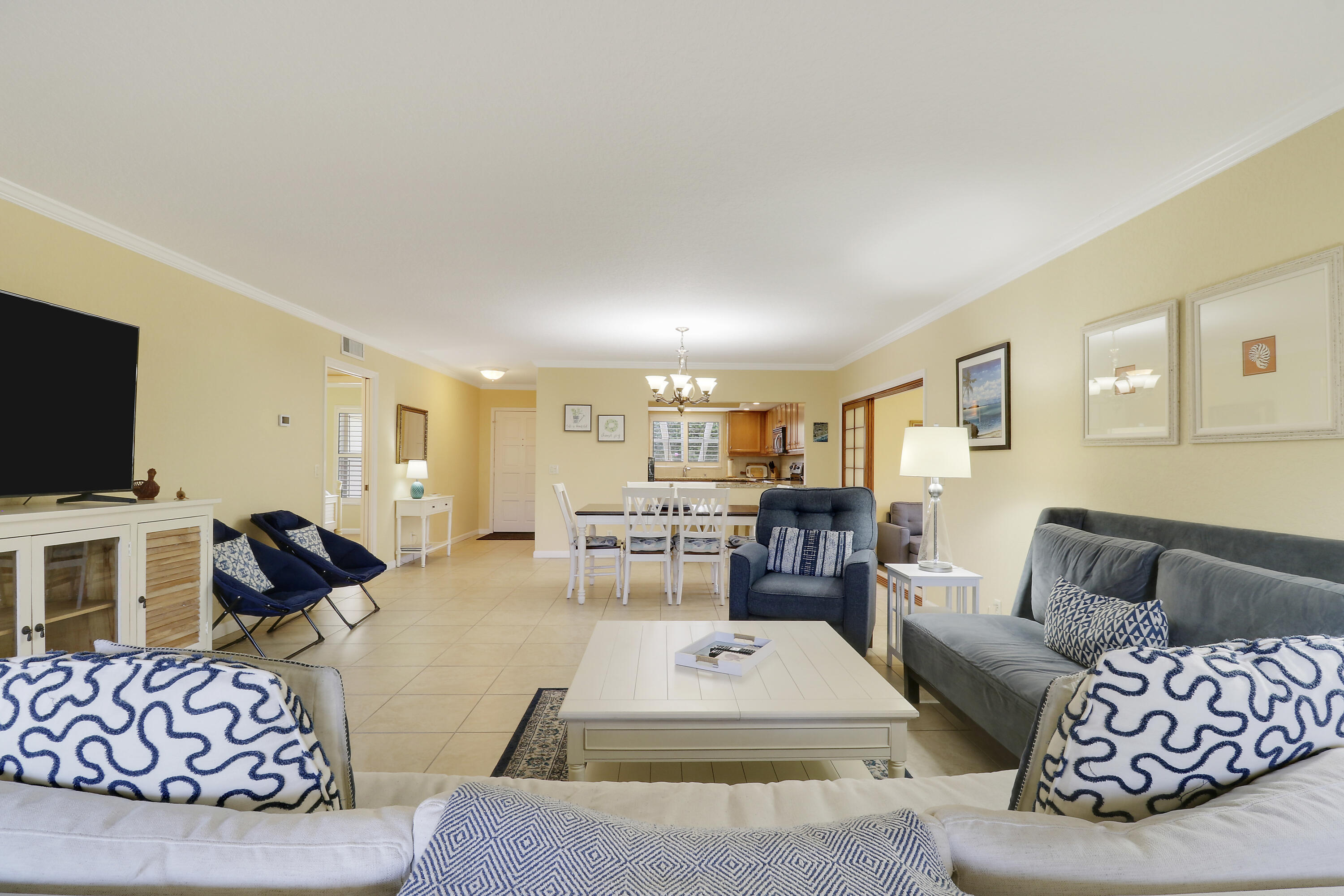 4161 U.S. Highway 1, Unit C2 Jupiter, FL 33477 - Photo 6 of 57 a living room with furniture and a flat screen tv