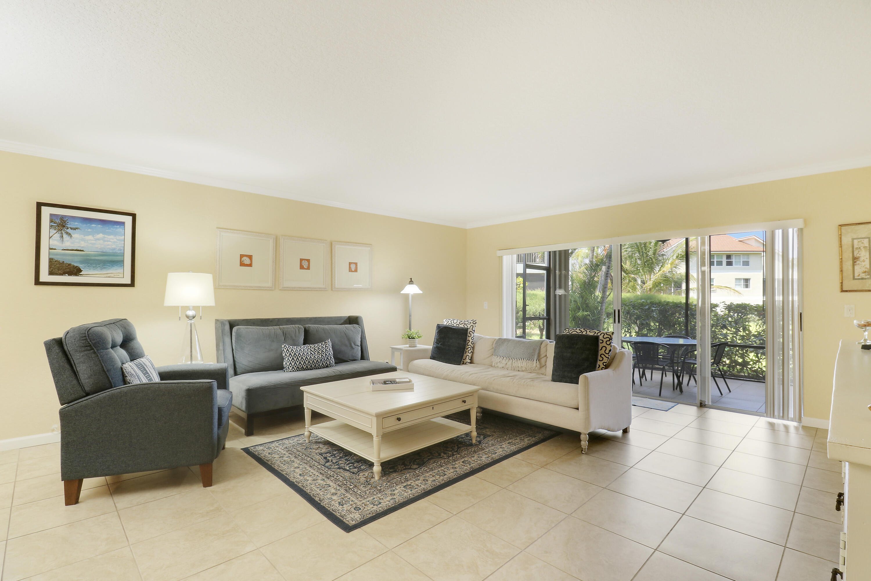4161 U.S. Highway 1, Unit C2 Jupiter, FL 33477 - Photo 7 of 57 a living room with furniture and a large window