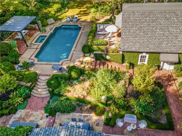 an aerial view of a house with a yard and potted plants