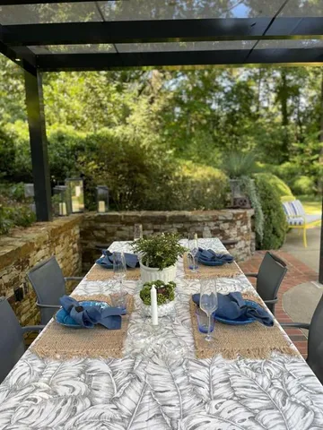 a view of a garden with plants and large trees