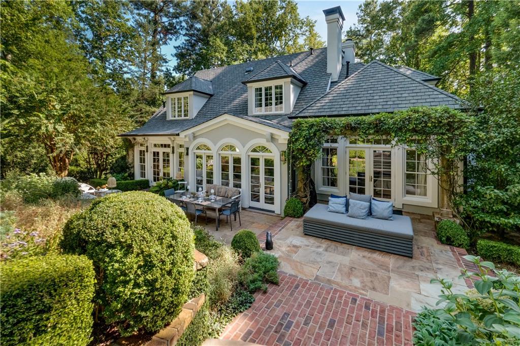 4224 East Conway Drive Northwest Atlanta, GA 30327 - Photo 16 of 72 a front view of a house with a yard table and chairs