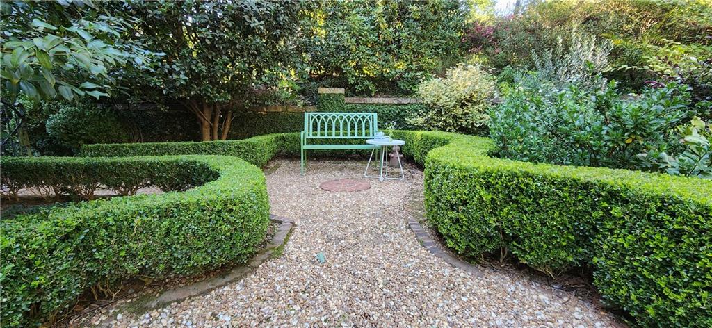 4224 East Conway Drive Northwest Atlanta, GA 30327 - Photo 18 of 72 a view of a garden with plants and large trees