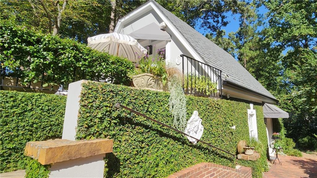 4224 East Conway Drive Northwest Atlanta, GA 30327 - Photo 20 of 72 a view of a house with a large windows and flower plants